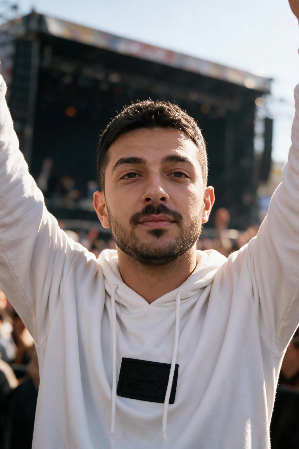 Vertical Reels cover idea: hands raised in a sunny festival crowd with the stage haze behind the shoulders